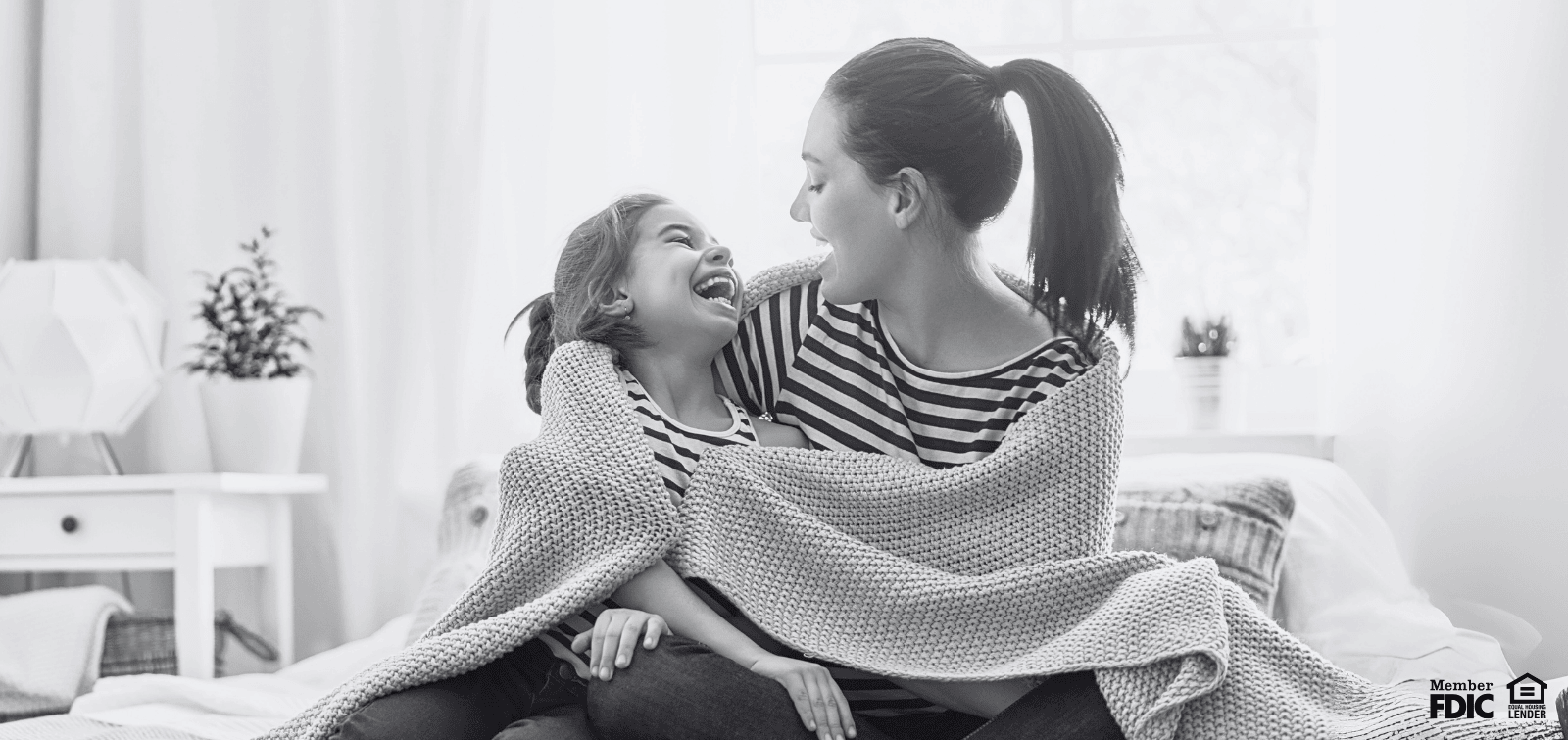 mother and daughter wrapped in a blanket