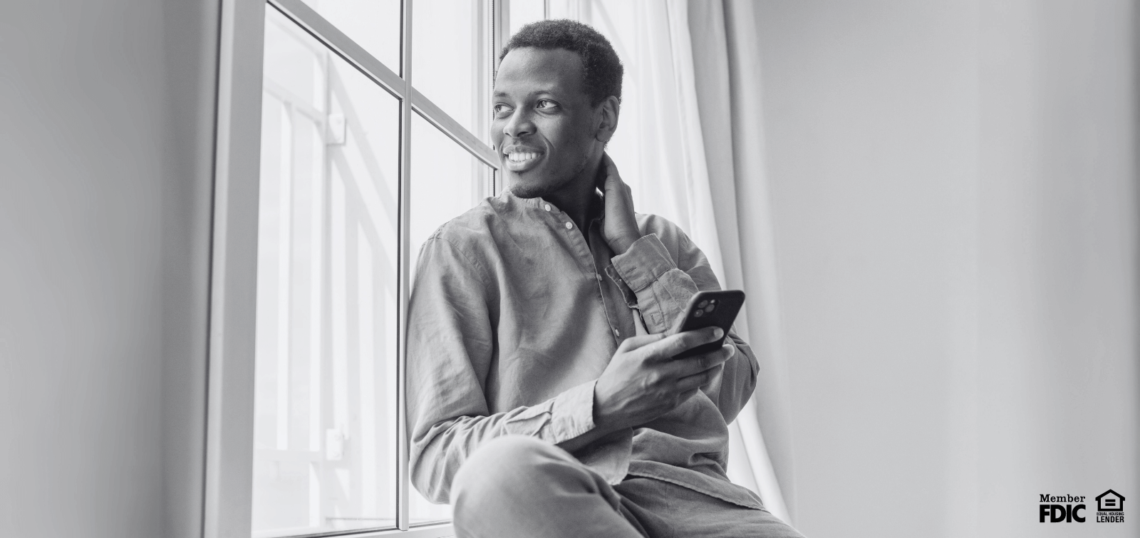 a young black man checks his credit score on his mobile banking app.