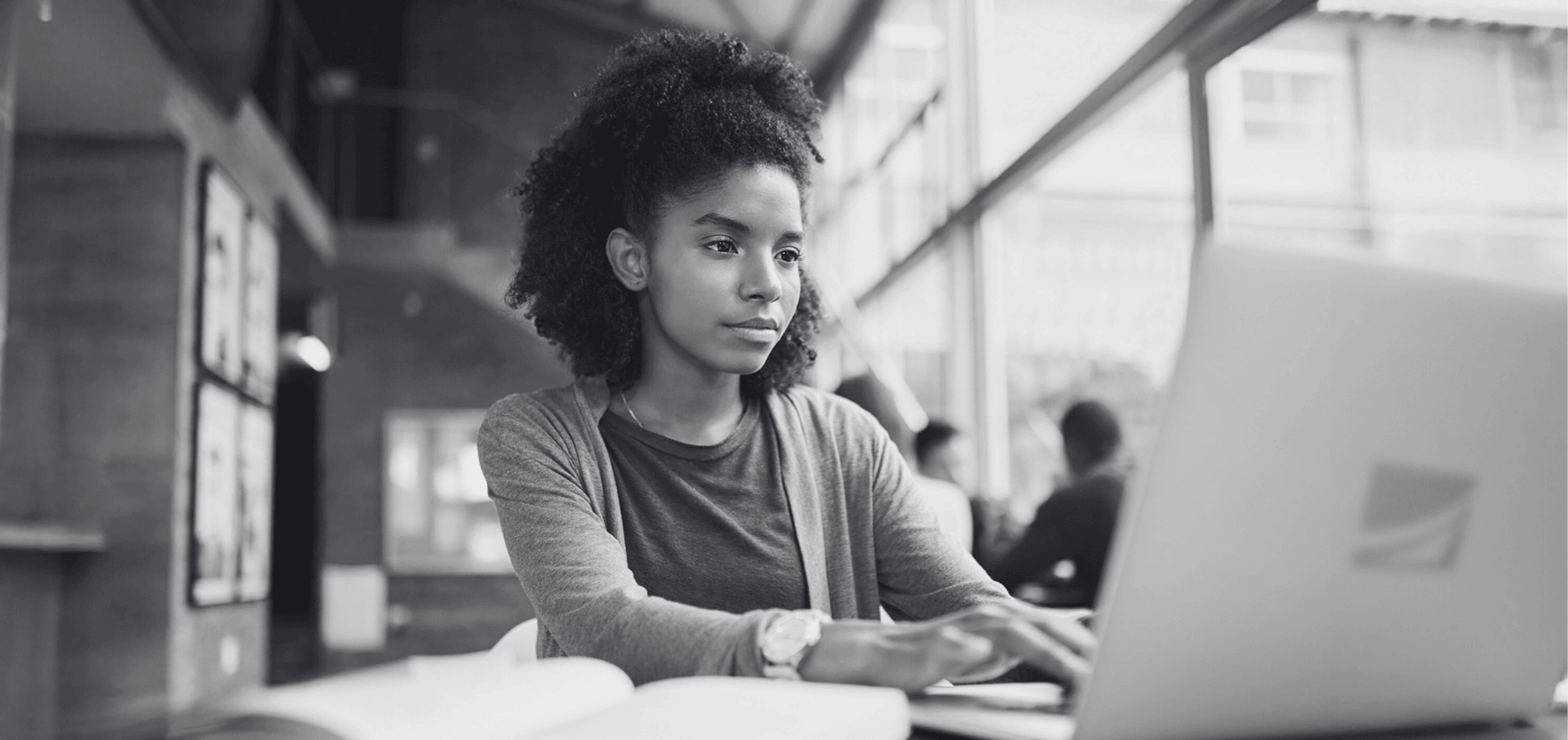 Female college student researching the best student savings accounts and student checking accounts.