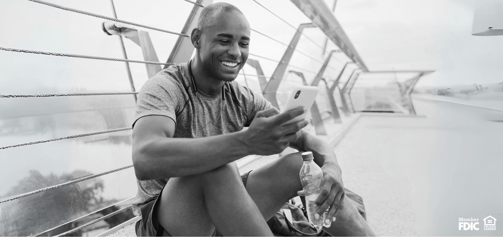 a military individual rests after a work out and checks online banking