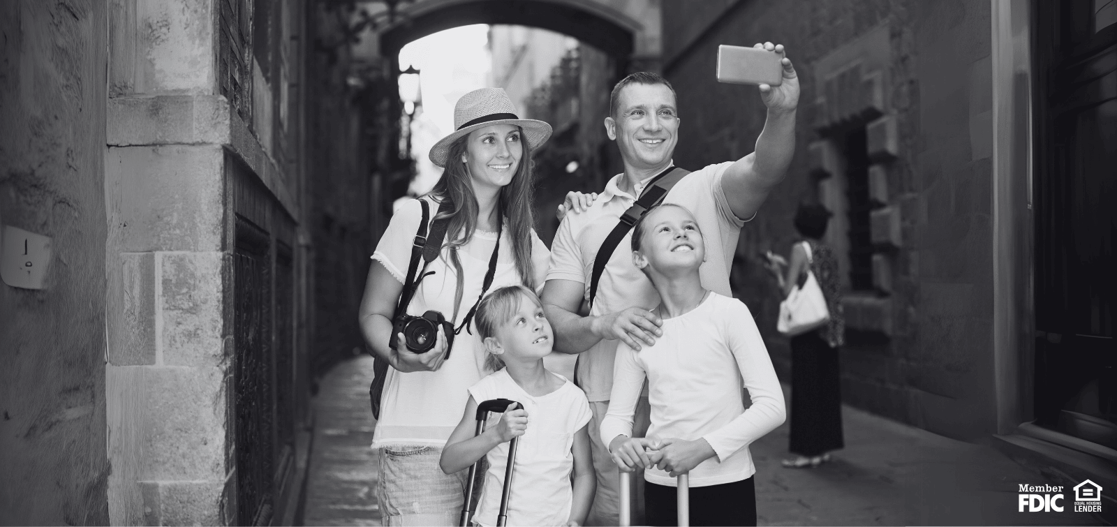 family of four taking a picture on vacation