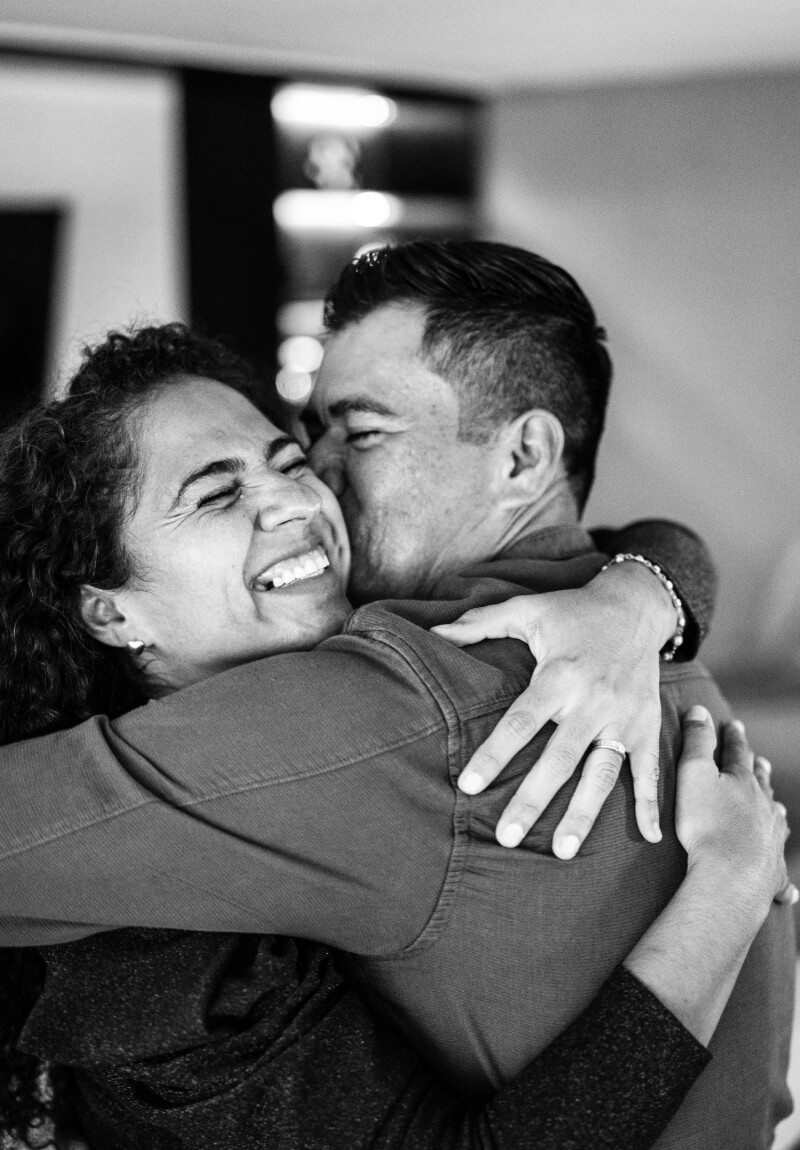 Couple smiling in an embrace in their living room