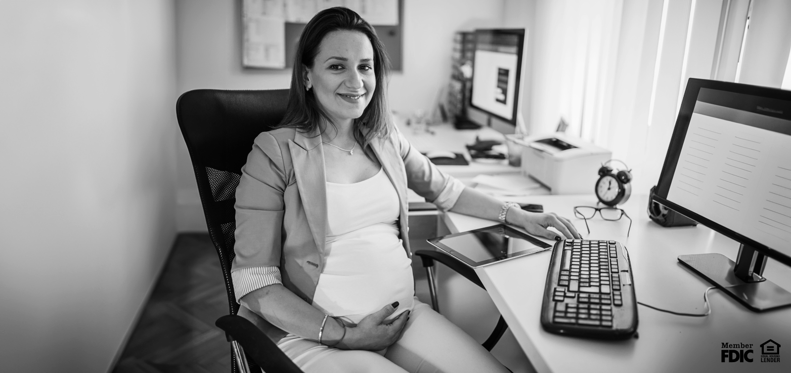 pregnant woman working in a small office