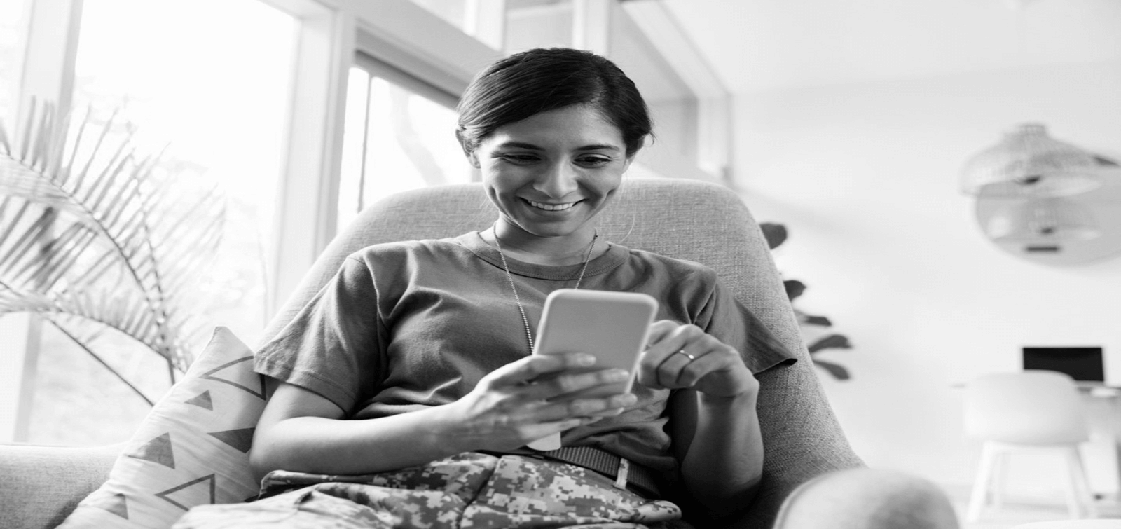 a military individual uses online banking to look up her account balances