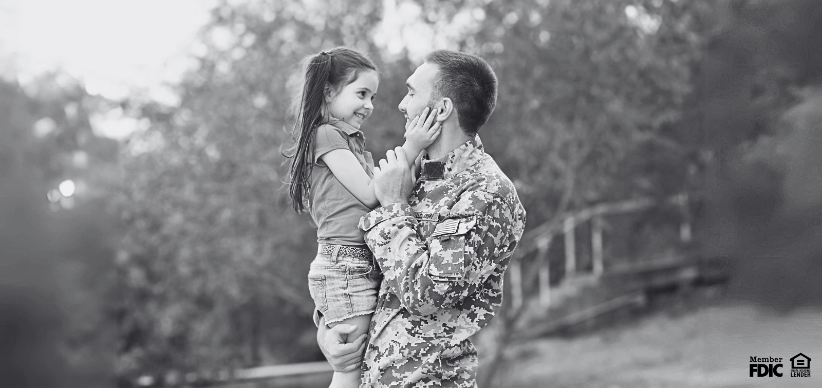 A soldier hugs his daughter. 