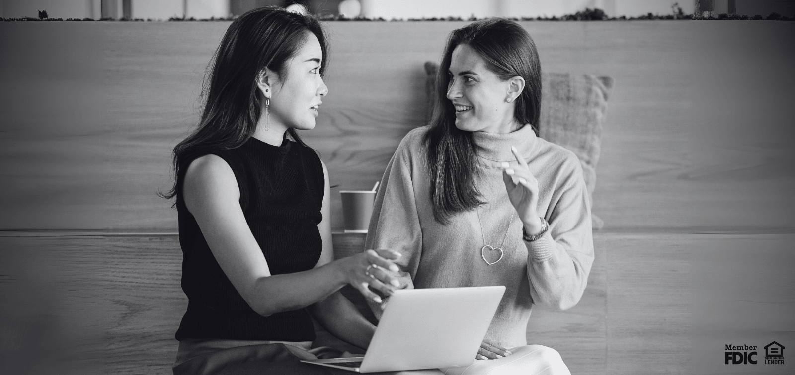 Two work colleagues discussing the pros and cons of business money market accounts.