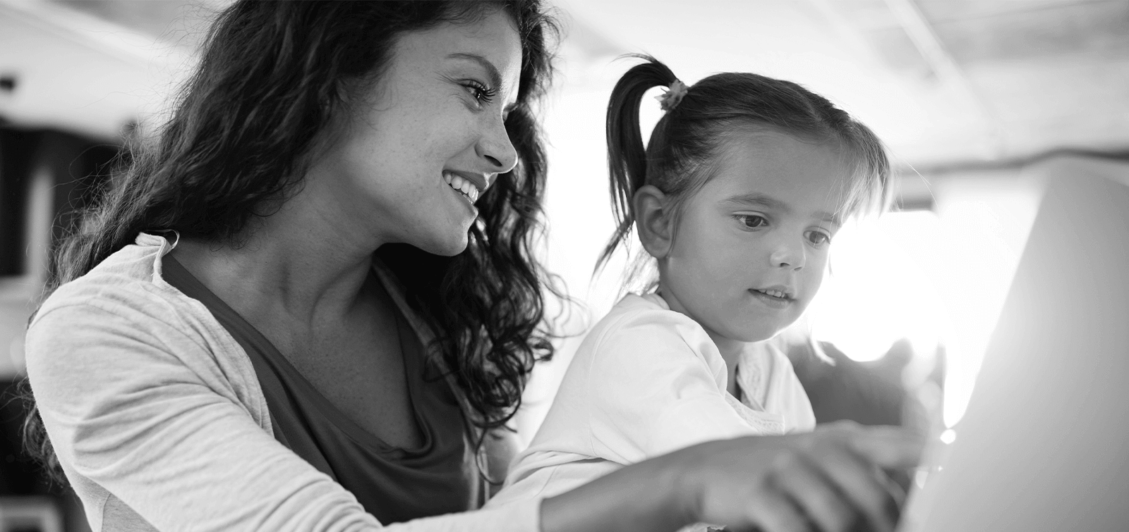 a mother looks at the best CD interest rates while her daughter sits on her lap.