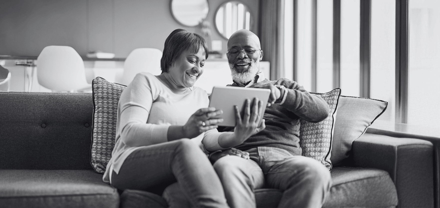Couple on couch, weighing the benefits of CD term loans.