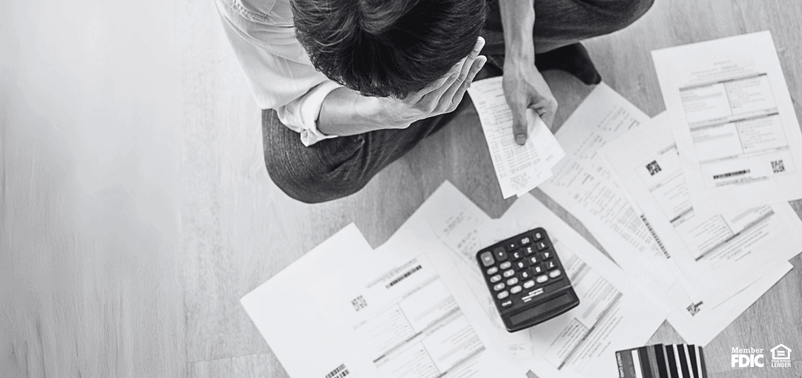 a person feels stress over a pile of bills